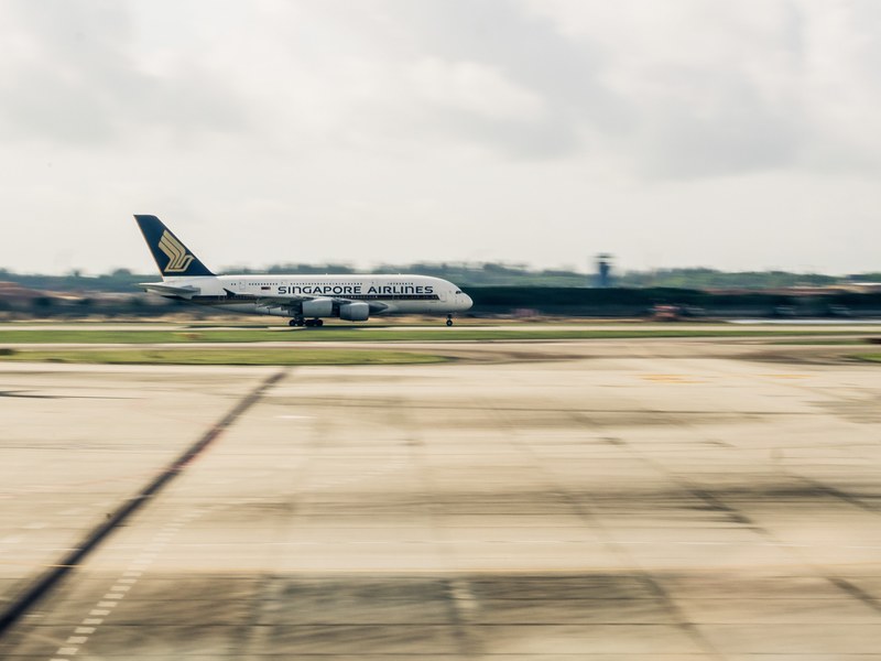 plane lifting off for flight at changi airport in singapore, plane starting to fly 4k
