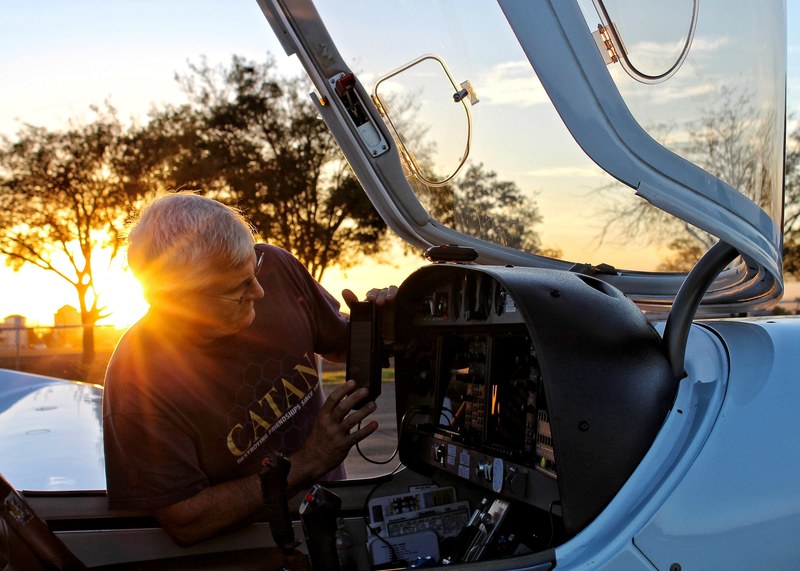a man inspecting the equipment of a plane at los banos municipal airport during sunset, plane inspection at los banos municipal airport 4k