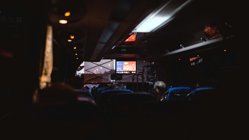 the dim interior of a coach driving through tokyo, first landing 4k