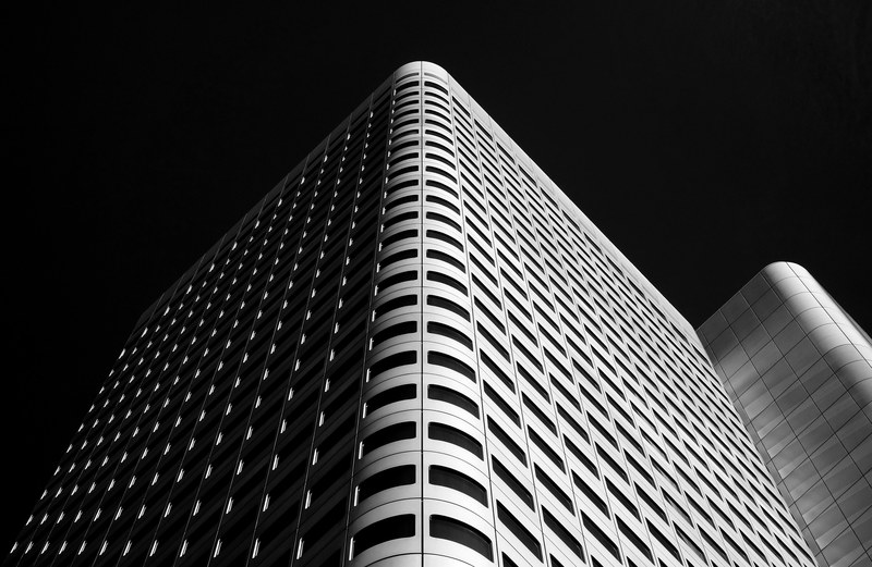 black and white shot of urban building with windows and dark sky in frankfurt hesse germany, silberturm 4k