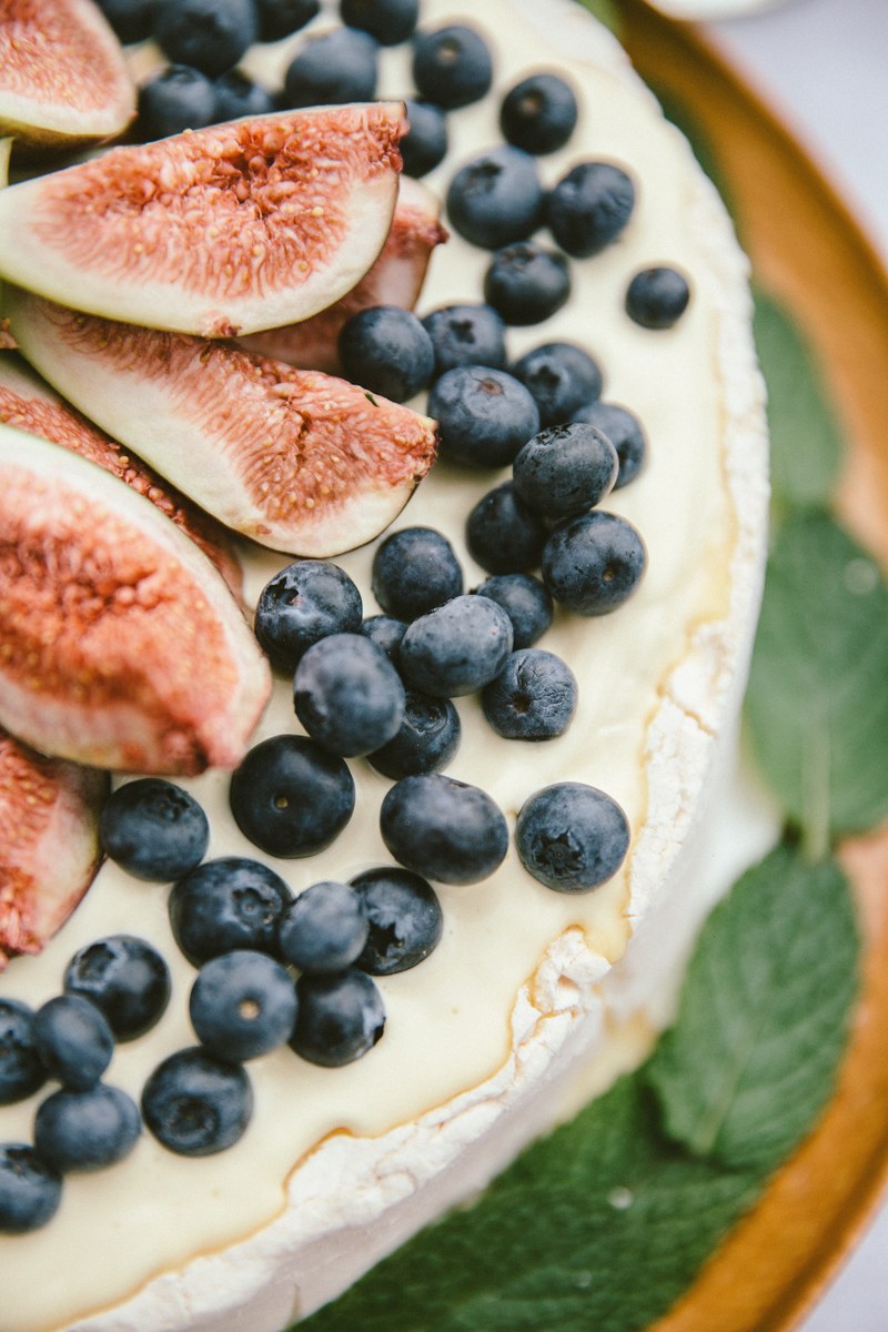 macro of a dessert cake with blueberries mint and figs, christmas food 4k
