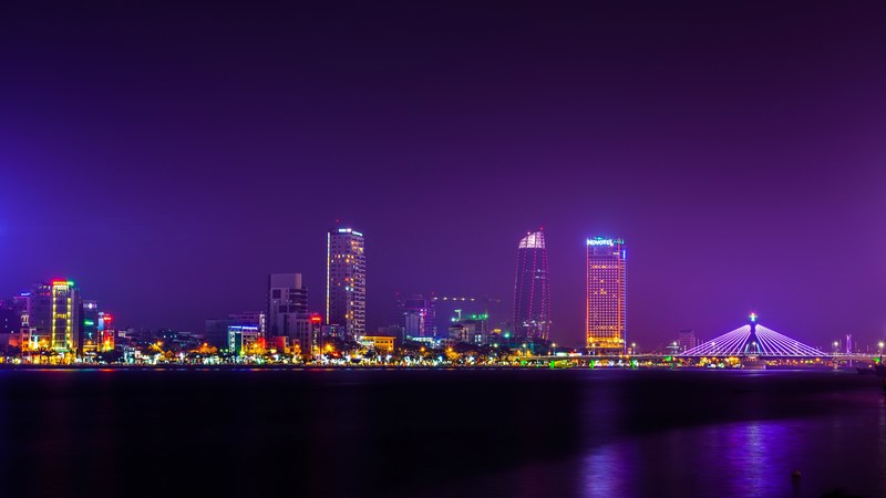 the bright skyline of da nang in vietnam seen from the river at night, bright da nang skyline 4k