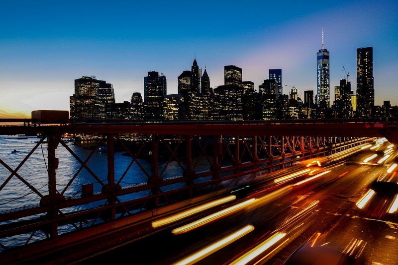 a long exposure shot of light trails on the freeway with the new york city skyline at the back, new york skyline with light trails 4k
