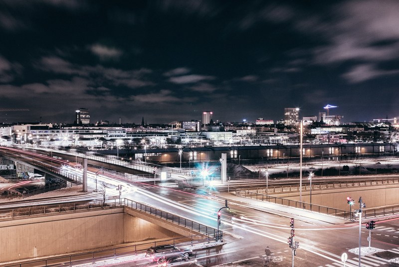 a ambient landscape shot showing the bright lighting and street light trails in copenhagen, copenhagen by night 4k