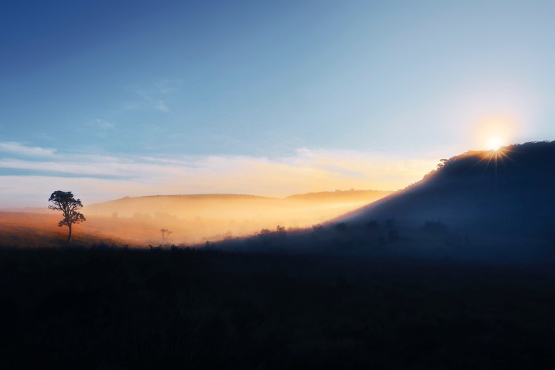 colorful sky shines on a silhouette of a rolling hillside in sri lanka, 4k