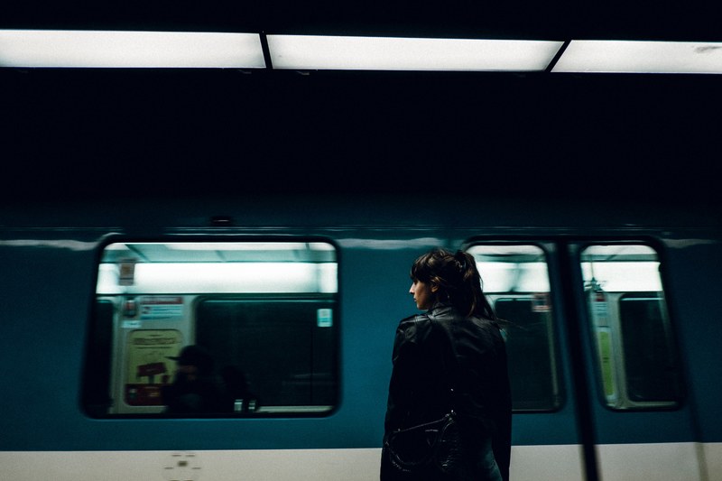 woman waits by passing subway train at metro stop in montreal, waiting for what 4k