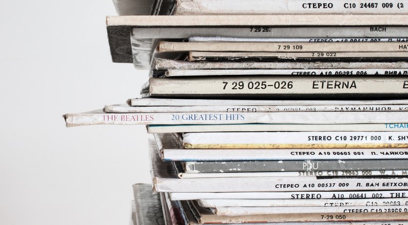 a close up of a stack of old vinyl records, vintage vinyl records 4k