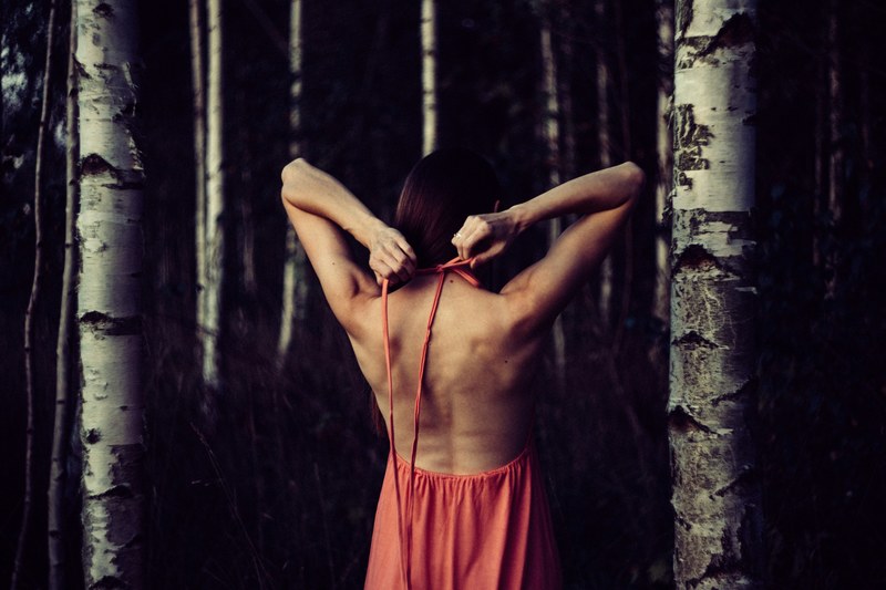 a girl stretching with her arms behind her back inside a forest, _stretching in forest 4k
