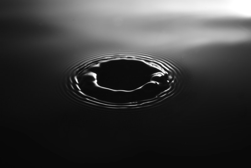 black and white macro shot of a ripple in the surface of water, monochrome water ripple 4k