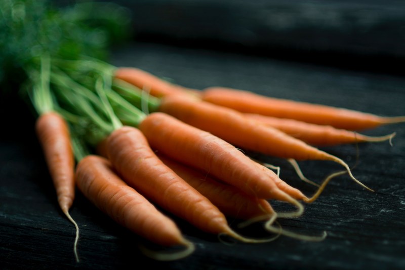 carrots laying on a table in wien, fresh carrots 4k