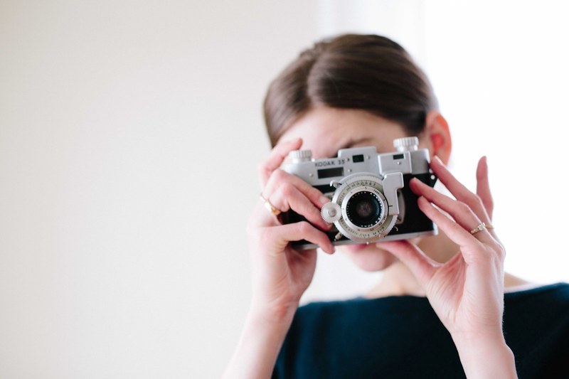 a woman taking a photo with a vintage kodak camera, kodak life 4k