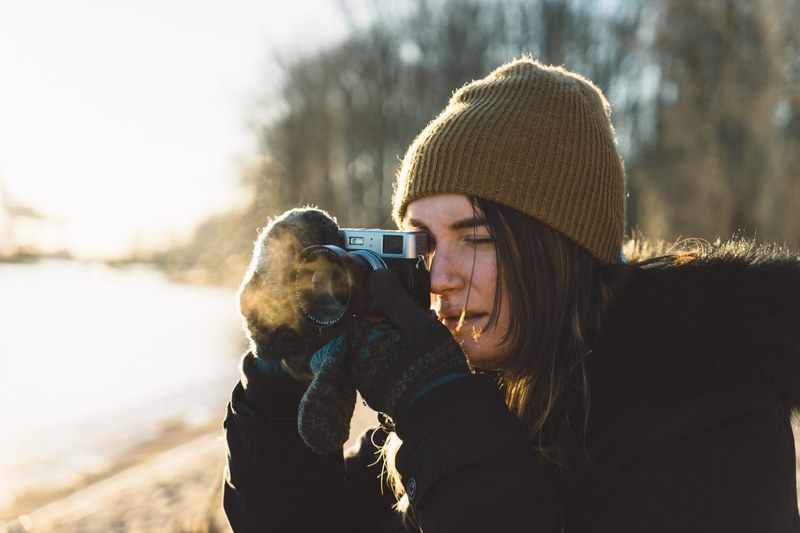 photographer takes a picture on a vintage camera on a cold day, shooting the sunrise 4k
