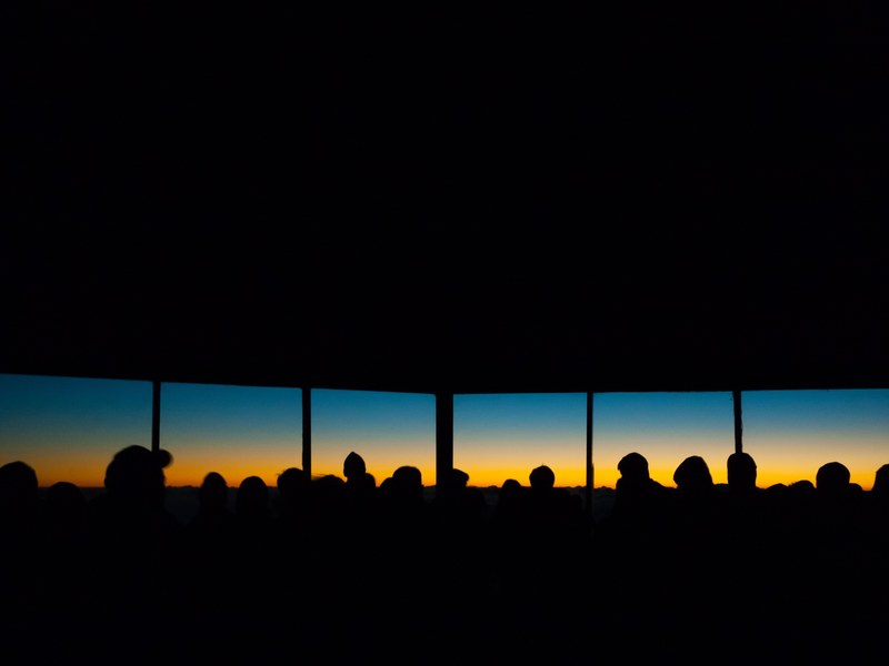 silhouette of people standing inside haleakala observatory watching the sunset through the windows, people haleakala observatory 4k