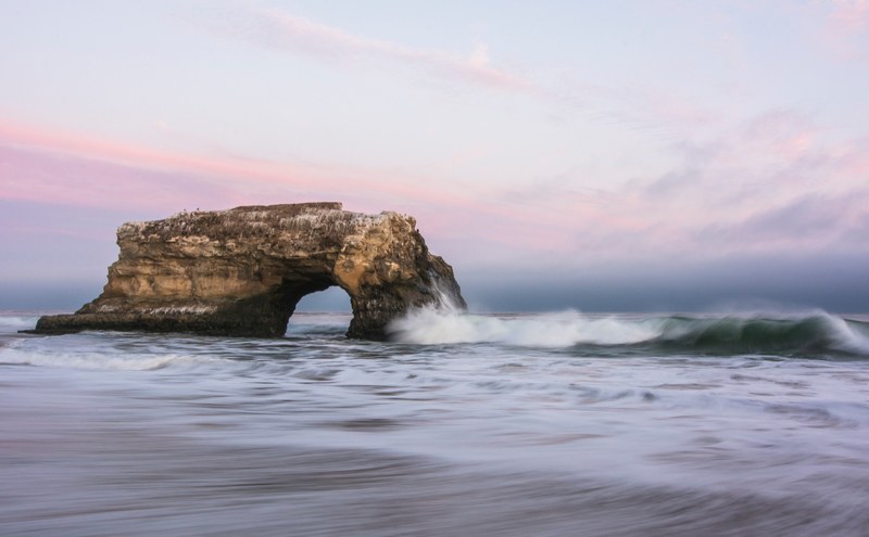 rock wave rock arch and ocean 4k
