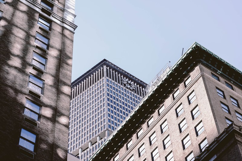 apartment building exterior with windows and skyscraper from below with blue sky in new york, apartment windows in new york 4k