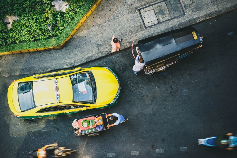 a top view on a bang wa street with a taxi motorbikes and an auto rickshaw, bangkok hustle 4k