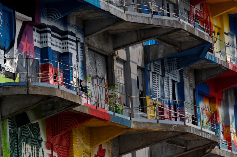 urban residential apartment buildings in pantin with colorful street graffiti street art on walls, balcony with view on street art 4k