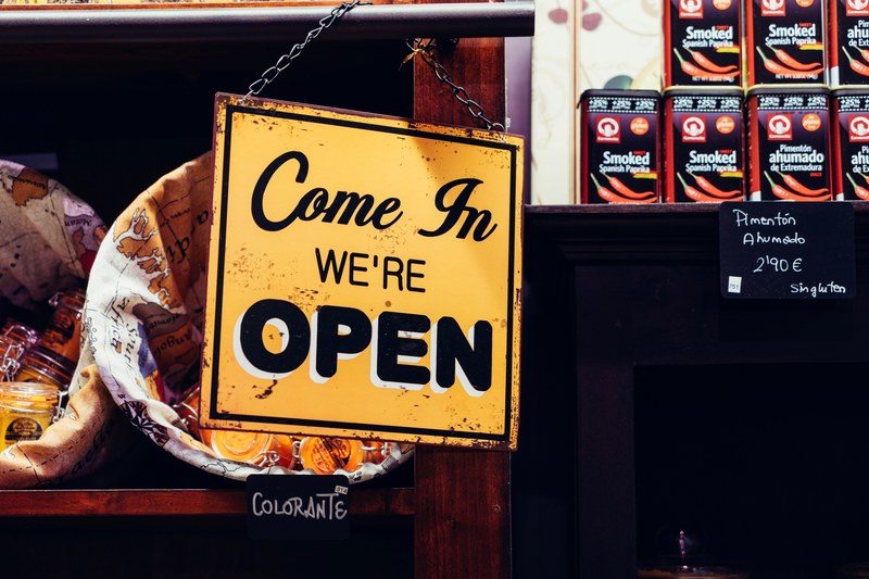 a come in were open sign hanging from a railing near the entrance to a store, were open sign 4k