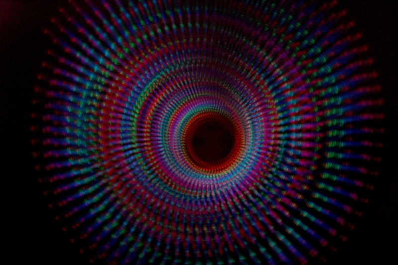 a spiral pattern of various color lights in a dark tunnel, _dark tunnel light spiral 4k