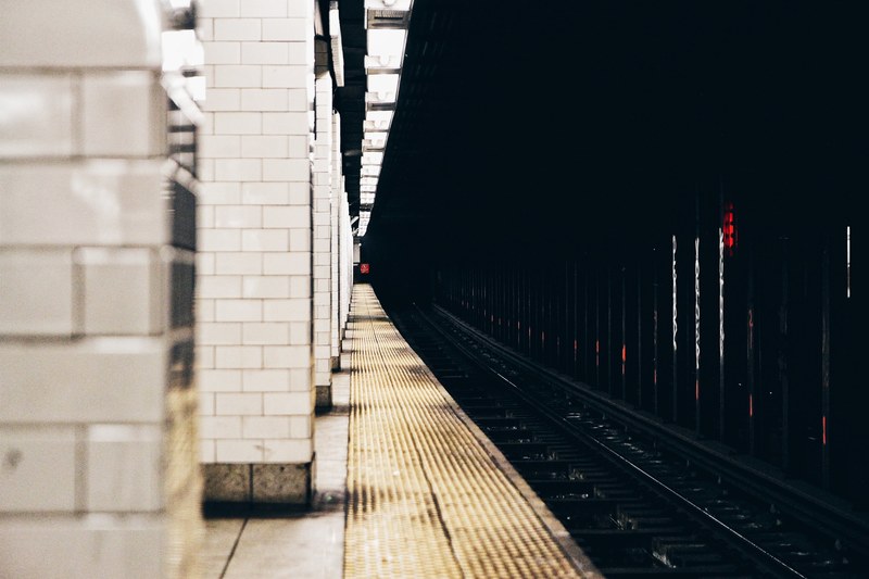 the view from the edge of the platform reveals a long stretch of subway track, _waiting on the platform 4k