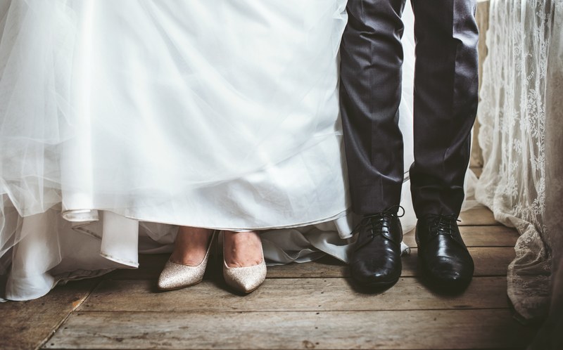 a bride and grooms feet in a white dress and black suit, wedding day 4k