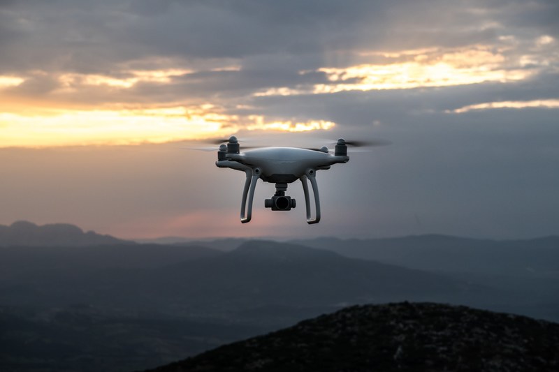 an aerial shot of a drone in flight over hilly terrain in greece during a cloud covered sunrise or sunset, drone flying over hills 4k
