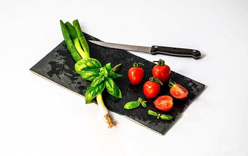 green onion basil and tomatoes on a black cutting board, marinara ingredients 4k
