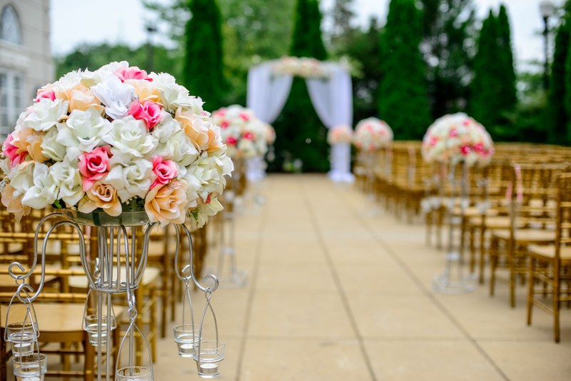 a scene prepared for a wedding with flower bouquets empty chairs and an altar, aisle for a wedding 4k