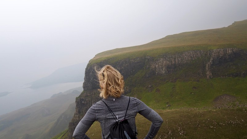 woman hiking through lush green highlands, hike on the quiraing 4k