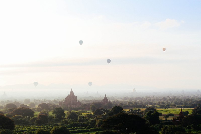 a landscape view of temples with hot air balloons going into the sky in old began, temples and hot air balloons_ 4k