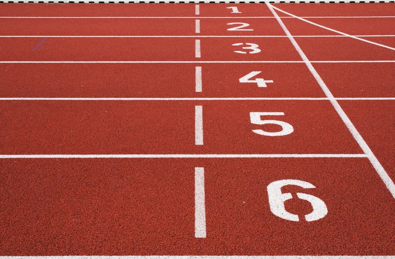 numbers on the starting line on a red running track, starting line on a track 4k