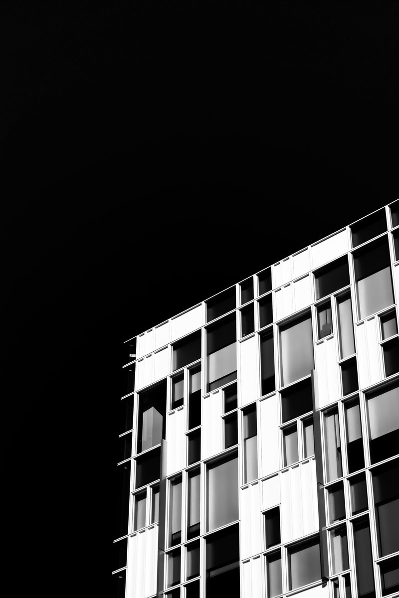 a black and white shot of a facade with rectangular windows in various sizes, black and white rectangles 4k