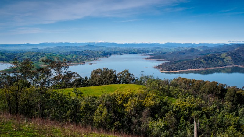 a picturesque landscape with a lake surrounded by wooded hills, hills near lake eildon 4k