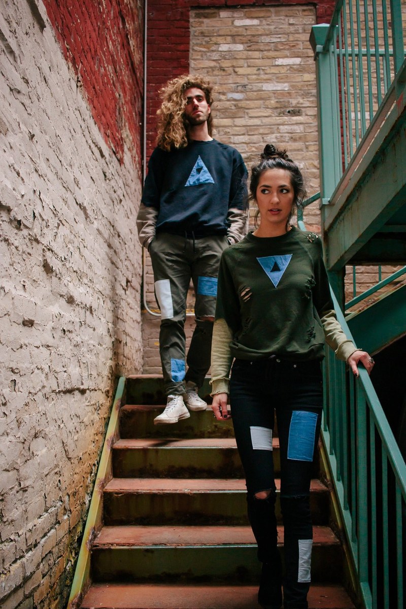 a young woman and a young man walking down the stairs in an old brick stairwell, prelude 4k
