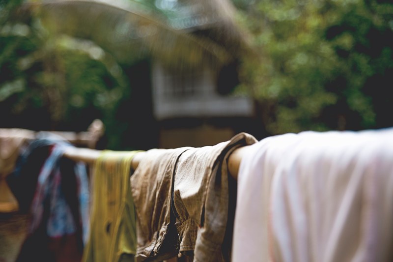 clothing drying on a bamboo pole in front of a building at noh bo academy, clothing drying on bamboo pole 4k