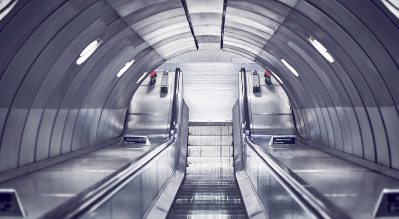 looking down a silver escalator in a steel tunnel at southwark street, going down 4k