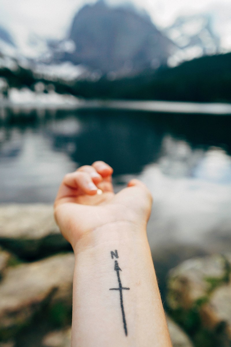 outstretched forearm with a tattoo of a compass on the wrist, compass tattoo 4k
