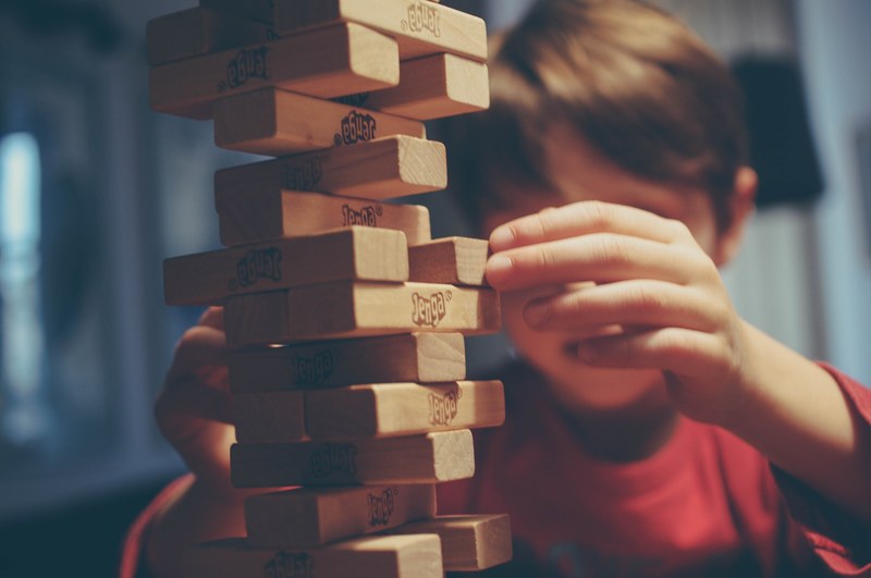 a child playing with a jenga block tower, playing jenga with my 6 year old 4k