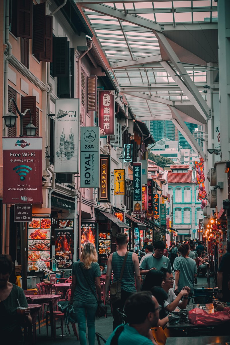 people in a street market with numerous bars and diners, chinatown street market 4k