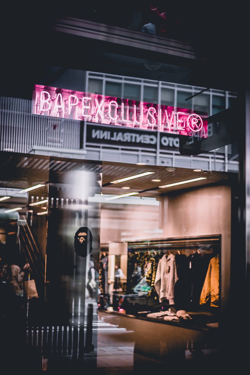 the interior of a clothing store seen through a window, clothing store window 4k