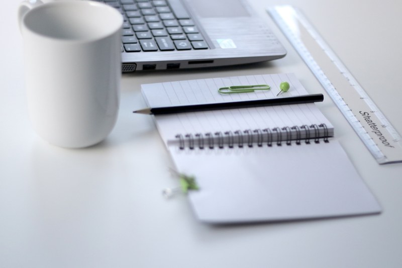 a notepad a ruler a mug and a laptop on a white desk, ruler and laptop on a desk 4k