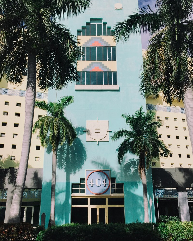 aqua blue hotel 404 and modern architecture with unique windows and palm trees, blue hotel building 4k