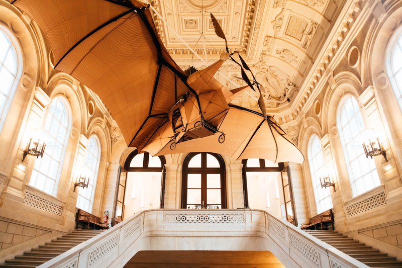 ornate stairwell and ceiling architecture with flying machine at metiers art museum, elegant architecture 4k