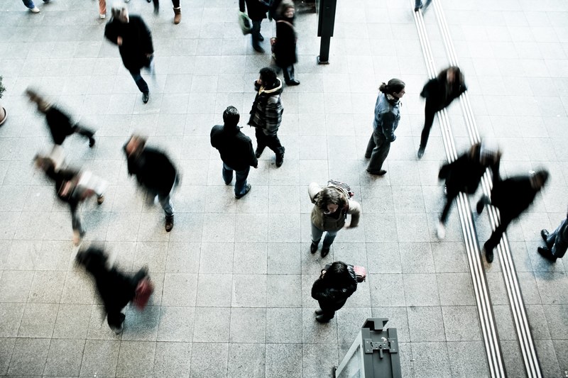 an overhead shot of people walking across a railway station, railway station from above 4k