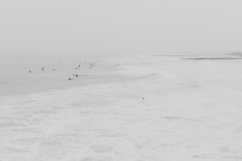 surfers enjoying the white sea at imperial beach under a white sky, surfers under the white sky 4k