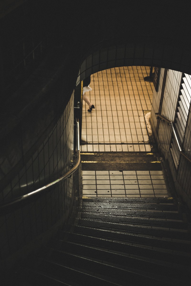 the stairs going down to the tube in trafalgar square, moment passing 4k