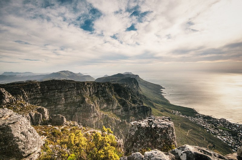 steep jagged cliffs on the seashore on a sunny morning, cliff under light clouds 4k