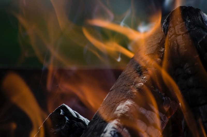 close up of scorched firewood on fire, by the warmth of the fire 4k