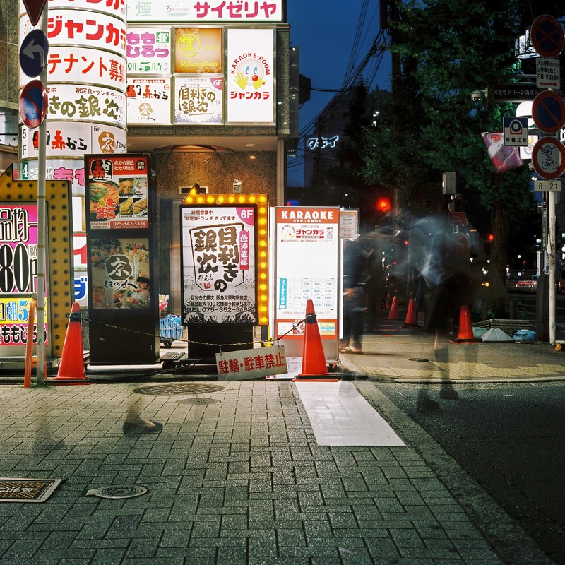 a long exposure shot of bright advertisements on a building wall in kyoto at night, advertisement neons in kyoto 4k