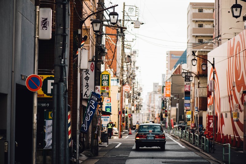 a car in a narrow street in an asian city, car in a narrow street 4k